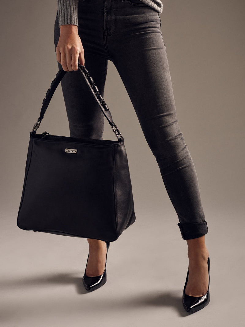 Model holding black Manhattan anti-theft handbag 